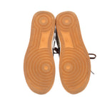 Women’s sneaker outsoles with tan rubber tread pattern and circular traction details