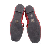 Red leather flats outsole view with black patterned tread and WEITZMAN text.
