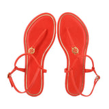 Red flip-flop sandals with TORY BURCH logo on footbed and tied toe straps