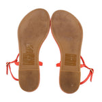 Red thong sandals showing tan underside and TORY BURCH logo on footbeds