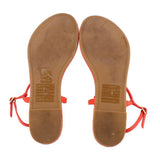 Red thong sandals showing tan underside and TORY BURCH logo on footbeds