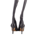 Black knee-high heeled boots shown from the back with slim heel