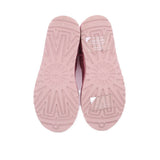 Pink suede booties showing textured rubber outsole tread