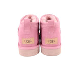 Pink suede booties with UGG logo patch on heel