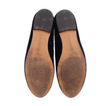 Navy slipper flats, view of tan footbed and worn soles