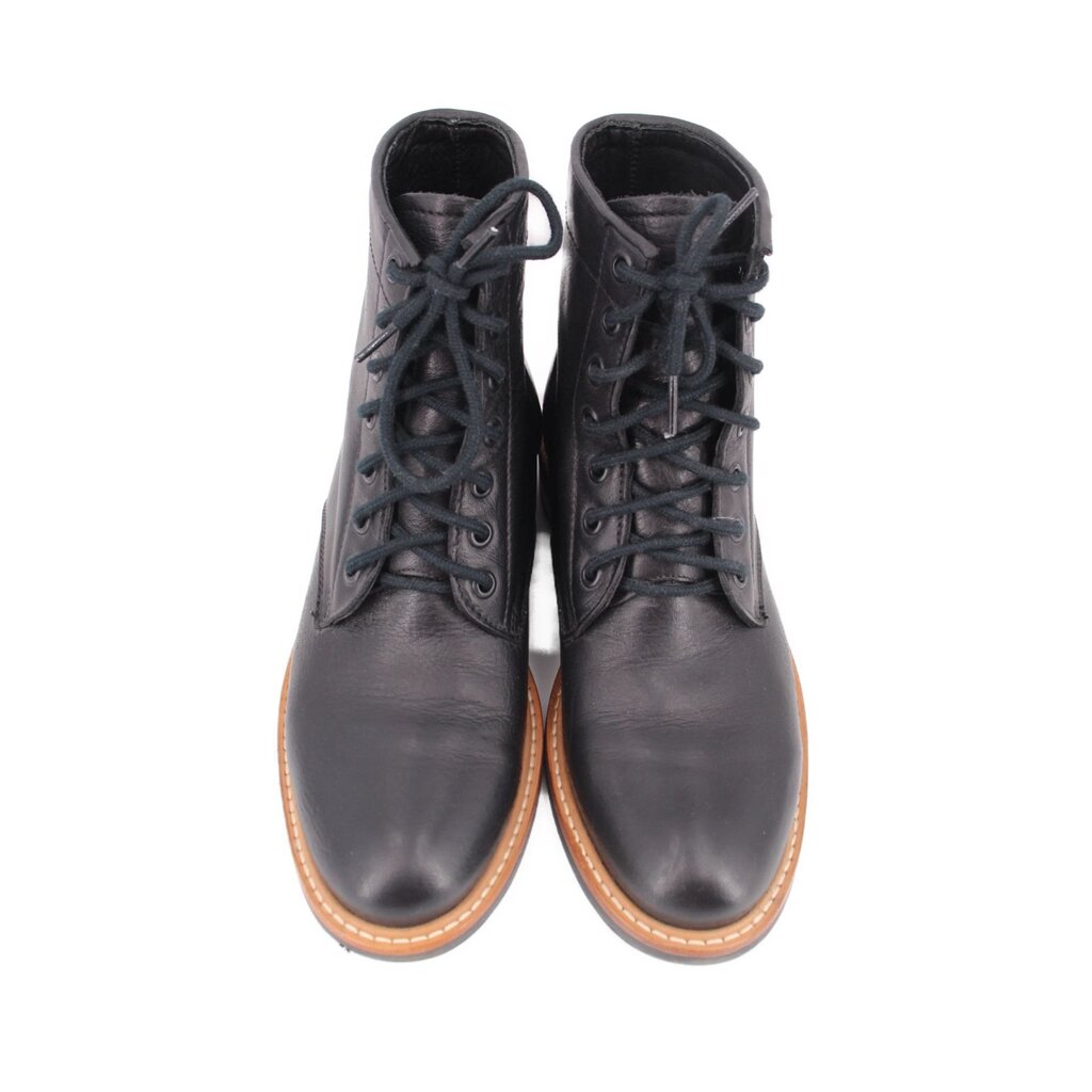 Pair of black lace-up booties with padded tongue and tan-trimmed sole