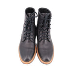 Pair of black lace-up booties with padded tongue and tan-trimmed sole