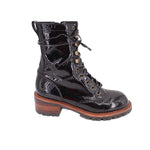 Black glossy lace-up ankle boots with gold eyelets and brown rubber lug sole
