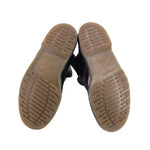 Boot soles showing beige rubber tread with black upper edges