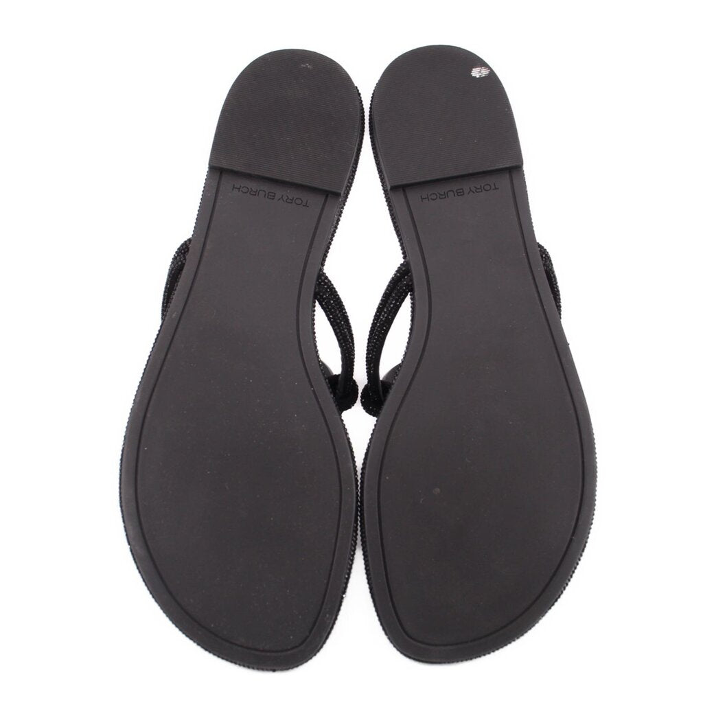Pair of black knotted thong sandals with textured sole and open toe
