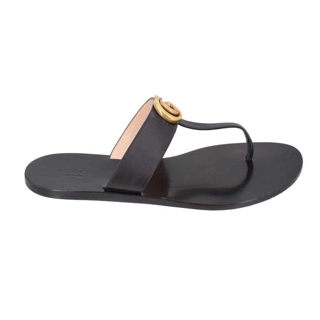 Black thong sandals with gold double-G detail and beige footbed