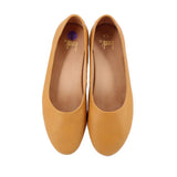 Pair of yellow leather flats with rounded toe and visible inner lining