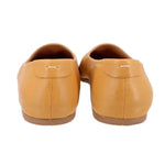 Yellow leather flats back view with stitched heel seam and small pull tab