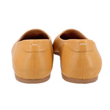 Yellow leather flats back view with stitched heel seam and small pull tab