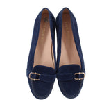 Pair of blue suede loafers with gold-toned buckle across the vamp