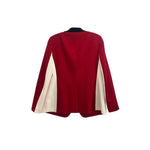 Back of red one-button blazer with cream contrast side panels and sleeves
