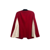 Back of red one-button blazer with cream contrast side panels and sleeves