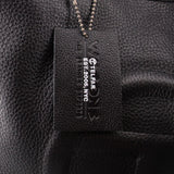Telfar logo brand tag on black leather bag interior, with small product text