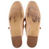 Tan patent flat outsoles with embossed markings on the heel and forefoot
