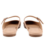 Tan patent flats from back view with ankle strap and low flat heel