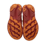Orange rubber outsole tread shown on mesh running sneakers
