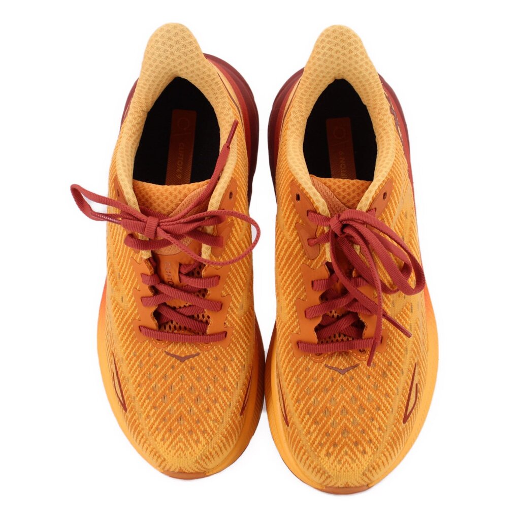 Orange mesh running sneakers pair with maroon laces, heel interior visible