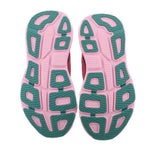 Pink-and-teal rubber outsole with deep tread pattern under sneakers