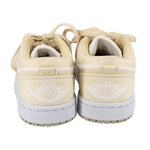 Women's low-top sneakers, tan with white heel logo and lace loops, rear view
