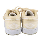 Women's low-top sneakers, tan with white heel logo and lace loops, rear view