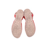 Red leather flats, view of treaded outsole with patterned grip