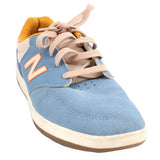 Blue suede New Balance tennis sneakers with beige laces and side N logo
