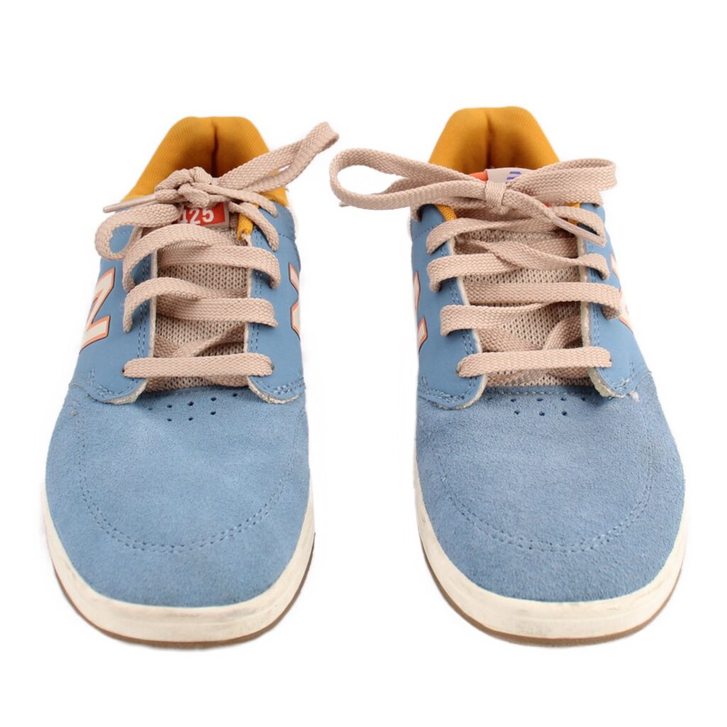 Pair of blue New Balance tennis sneakers with beige laces, toe perforations, and N logo