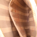 Striped fabric lining inside crossbody bag with BRAHMIN logo stamp on panel.