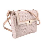 Cream embossed leather crossbody bag with front flap pocket and adjustable crossbody strap.