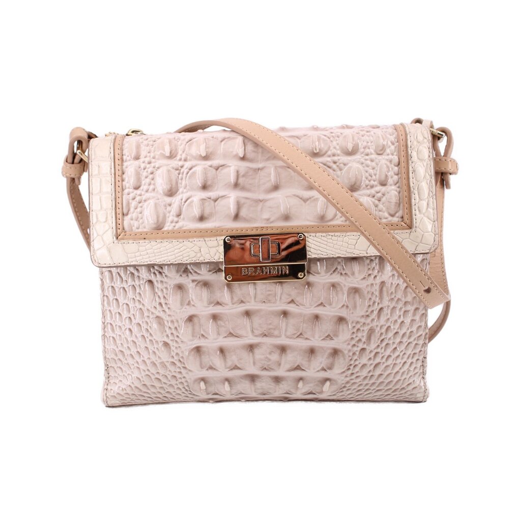 Cream embossed leather crossbody bag with logo plaque and adjustable strap.