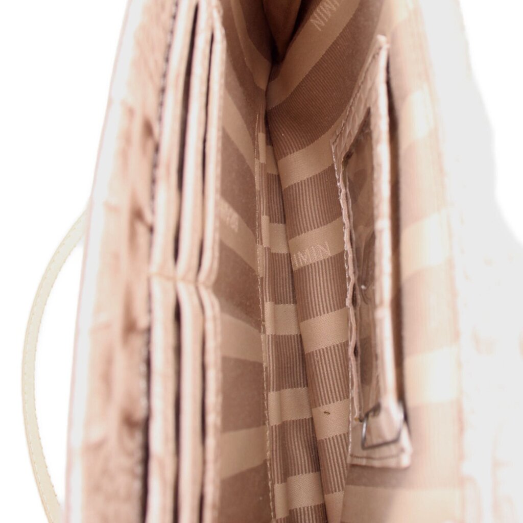 Cream fabric lining with striped pattern inside crossbody bag, visible interior panel.