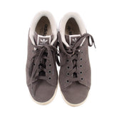 Pair of Adidas mid-top sneakers, dark gray suede with black laces and cushioned white collars
