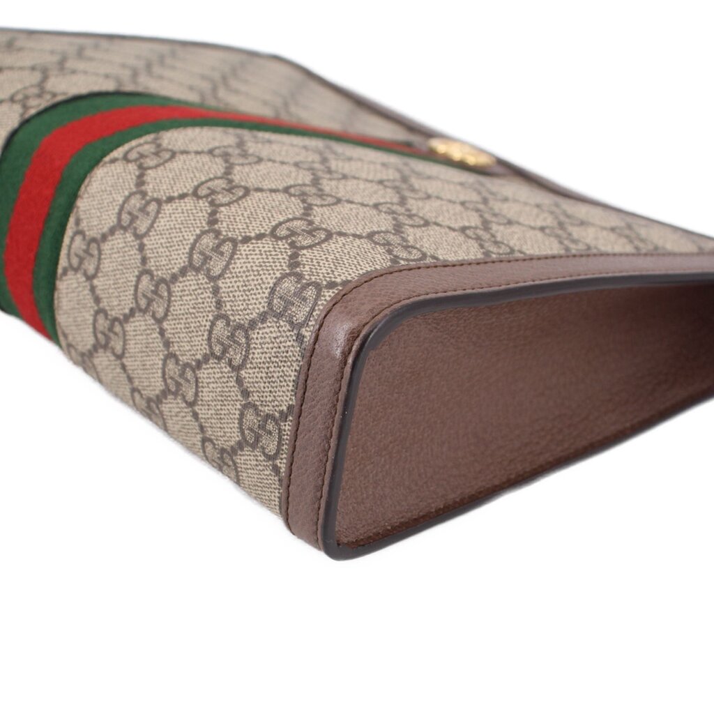 GUCCI Ophidia pouch corner close-up on brown base edge and GG canvas