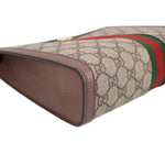 GUCCI Ophidia pouch corner close-up, brown leather trim and GG canvas texture