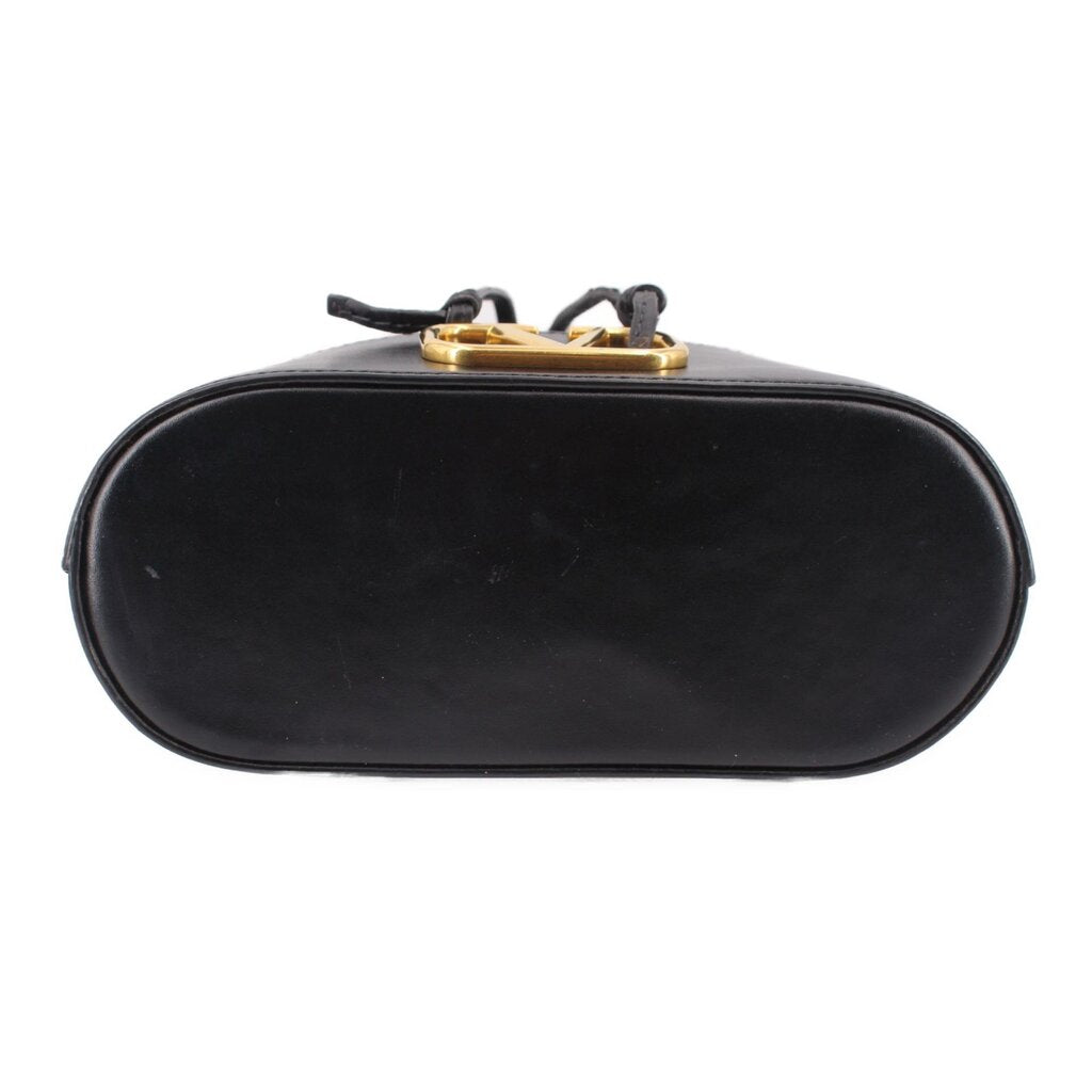 Black mini bucket crossbody bag back view with gold hardware and top handle straps