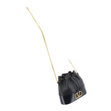 Black mini bucket crossbody bag with drawstring top and long gold chain strap