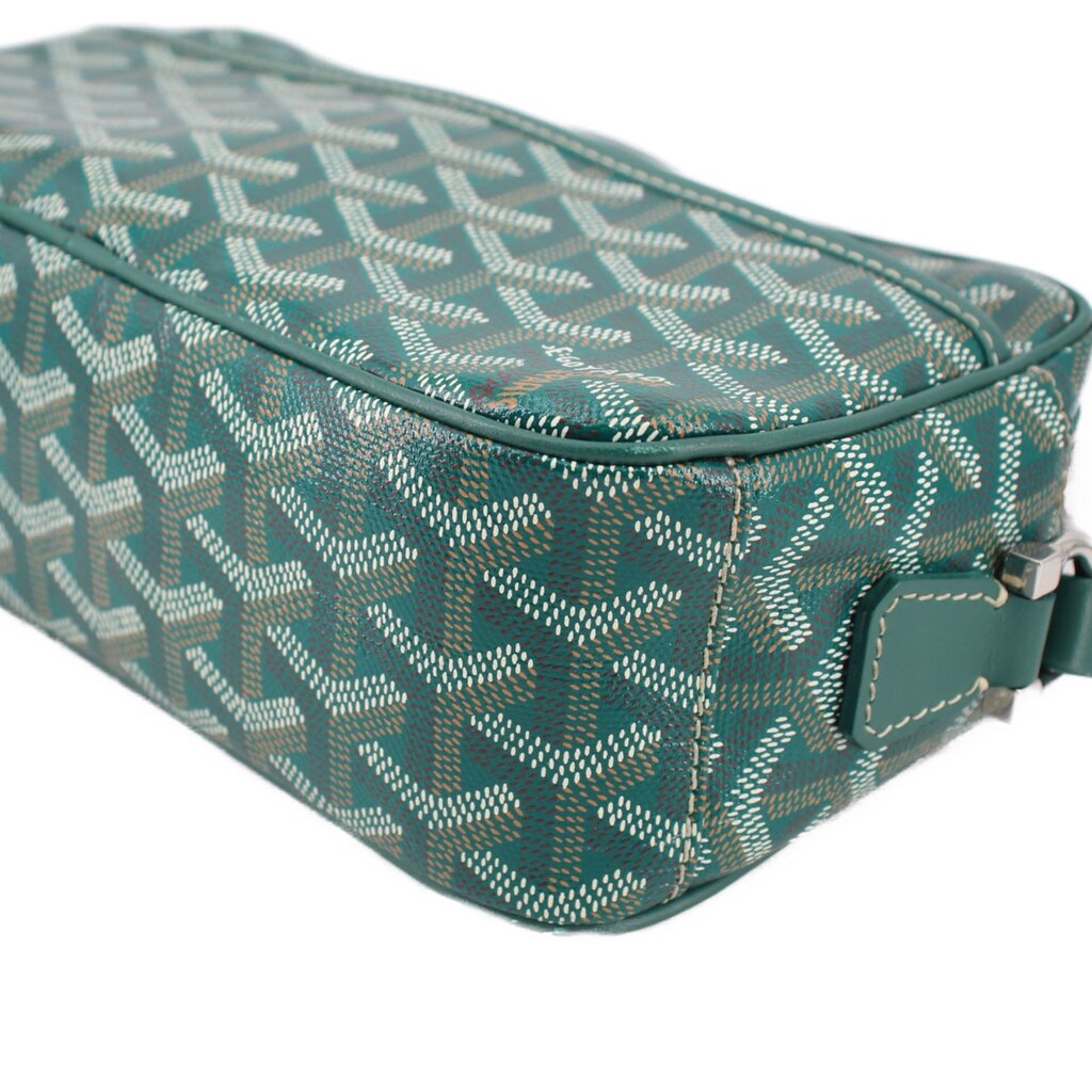 Close view of GOYARD green patterned crossbody bag with teal edge trim and zipper