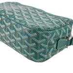 Close view of GOYARD green patterned crossbody bag with teal edge trim and zipper
