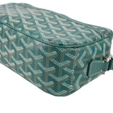 Close view of GOYARD green patterned crossbody bag with teal edge trim and zipper