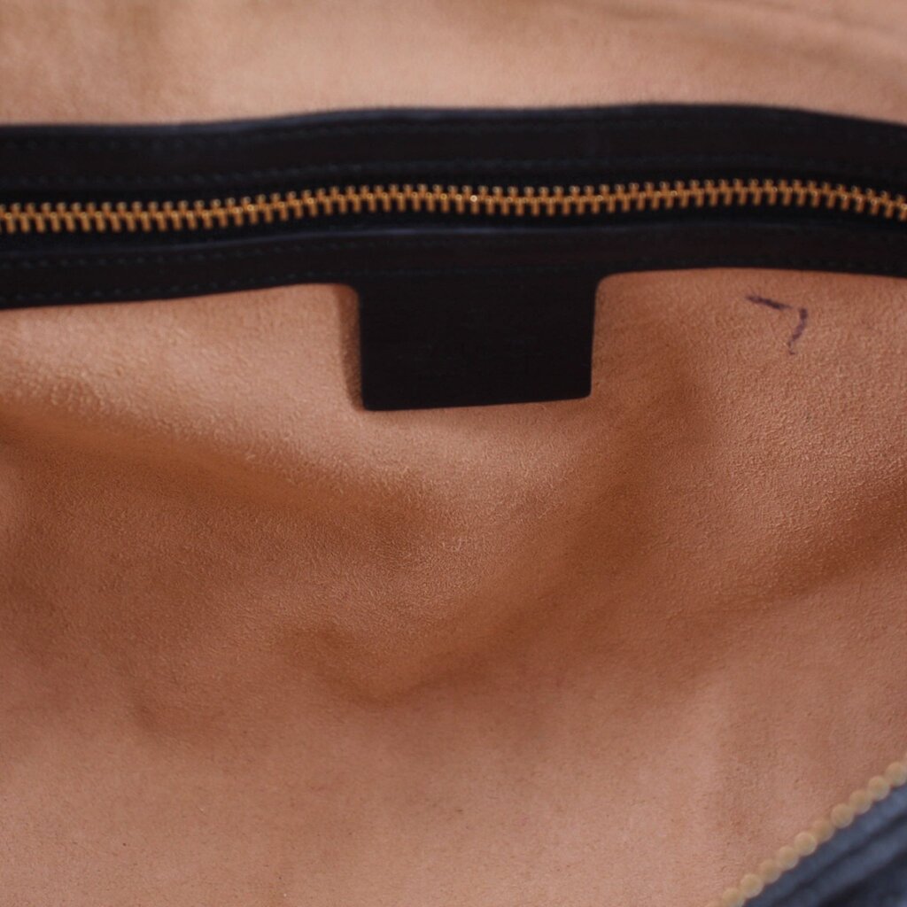 Crossbody bag interior lining with zipper track and dark fabric pocket panel