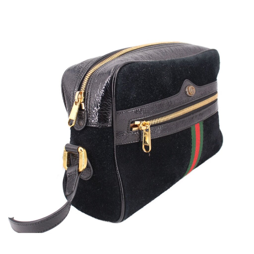 Black suede crossbody bag with gold zippers, leather strap, and green-red web stripe