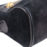Black suede crossbody bag with gold-tone zipper pull and rounded flap detail