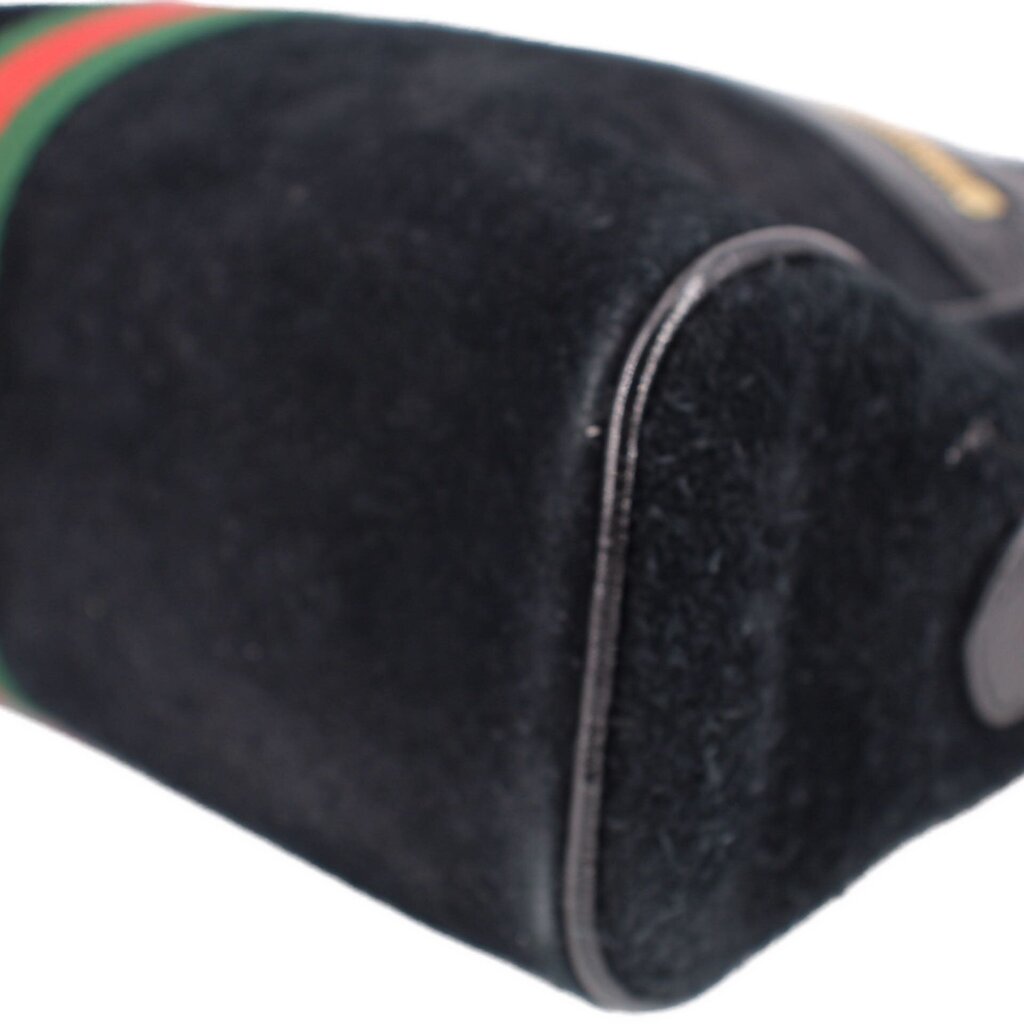 Black suede crossbody bag side seam and trim with edge of green-red stripe