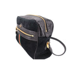 Black suede crossbody bag with front flap, gold zipper, and green-red web stripe