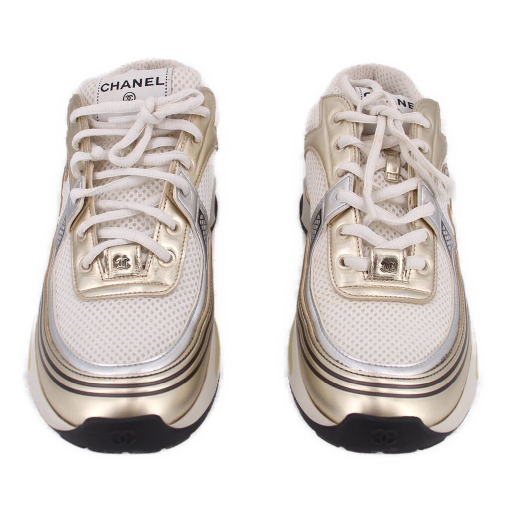 Pair of CHANEL tennis sneakers in white with gold toe and side logo, lace-up design